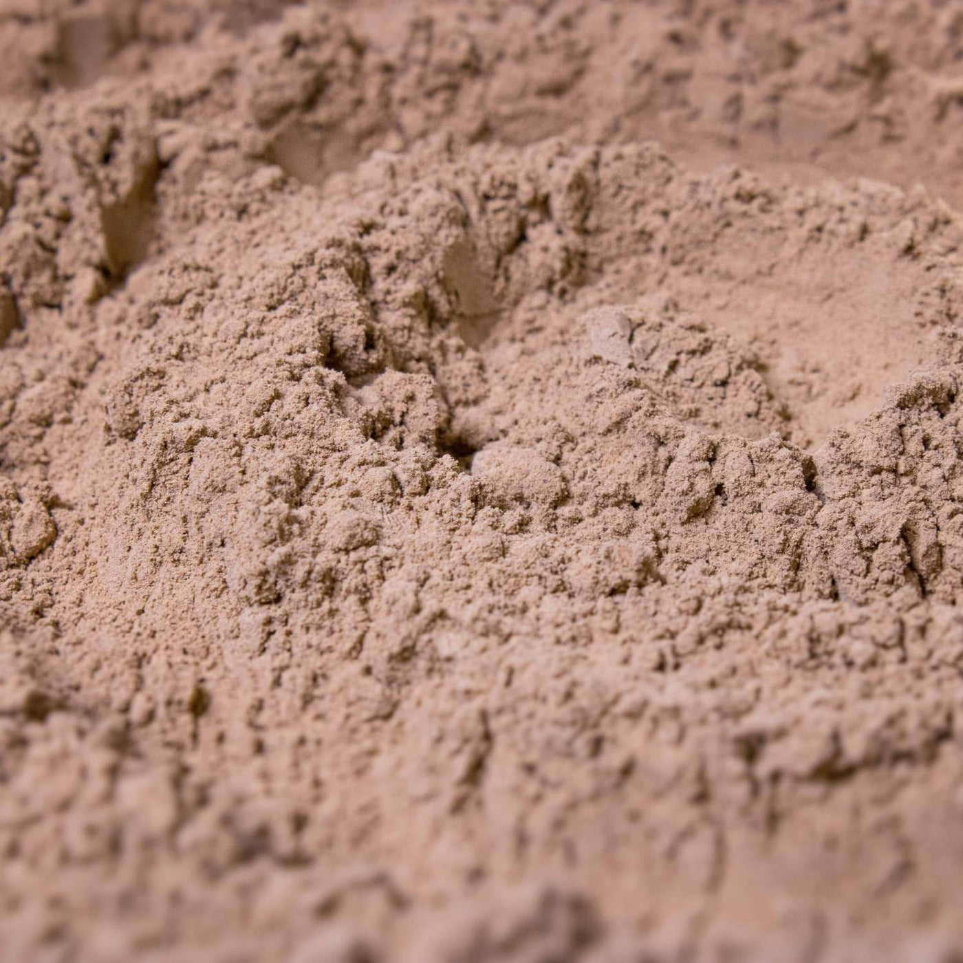 Organic clay soil amendment in a rustic setting, specifically designed to improve terrarium environments for thriving plant ecosystems.