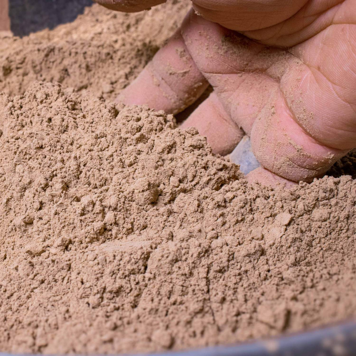 Versatile clay powder shown with terrarium tools, essential for DIY terrarium enthusiasts looking to optimize their soil mixture.